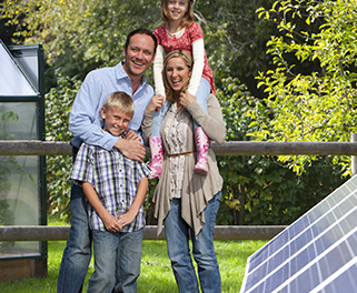 Family standing next to their new renewable solar panel