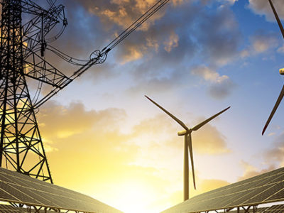 Wind Turbines and Solar panels with the sunset in the background