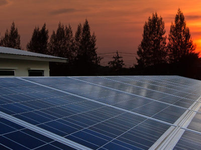 Solar panels soaking up the setting sun's energy during orange skies