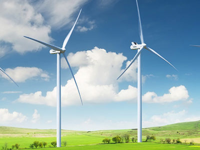 Wind Turbines in a beautiful green field on a sunny day