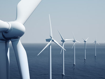 A line of wind turbines in the ocean