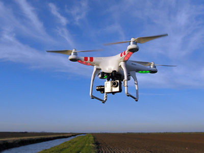 Drone flying around above a field