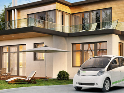 Electric car being charged in front of an eco-friendly built house