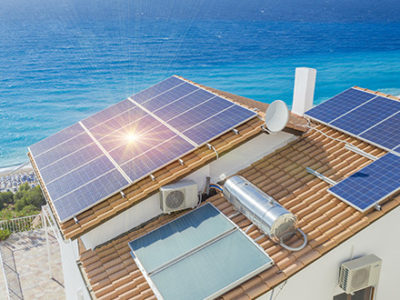 Solar panels on top of a house next to the beach