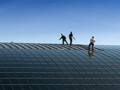 Green-energy-providers-putting-solar-panels-on-building