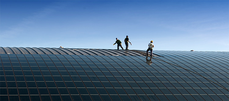 Green-energy-providers-putting-solar-panels-on-building