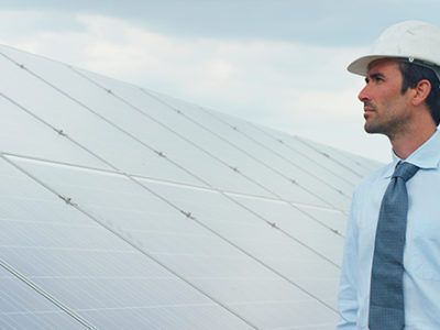 Worker-pictured-in-front-of-solar-panels