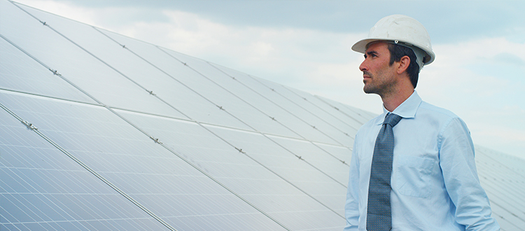 Worker-pictured-in-front-of-solar-panels